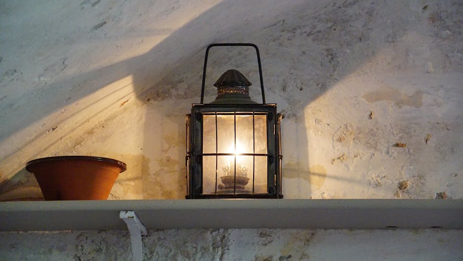 pexels-photo-109561-109561 A vintage lantern casting warm light and shadows in a rustic interior setting.